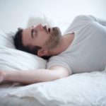 Man in Bed Snoring While Sleeping